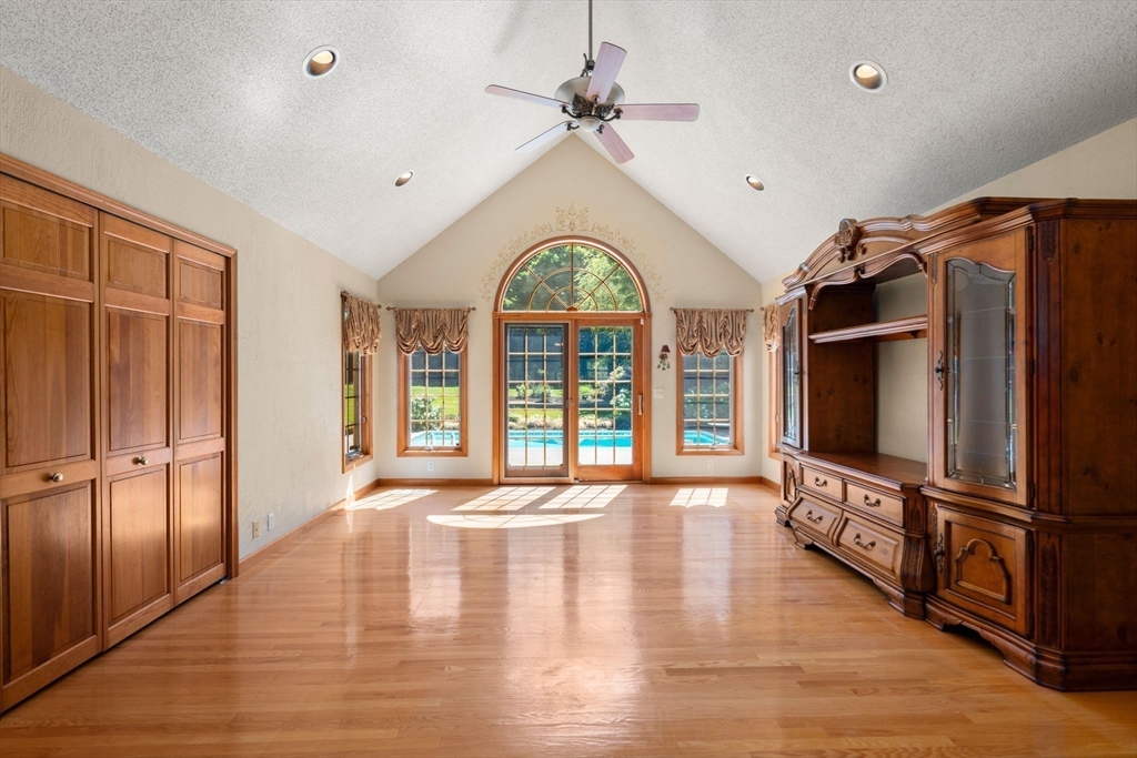 2035 Parker Street Springfield, MA 01128 - Photo 4 of 42 a view of an empty room with wooden floor a kitchen view and windows