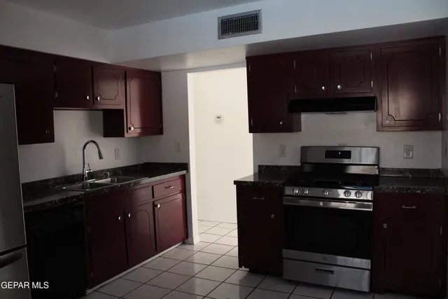 a kitchen with a sink and a stove