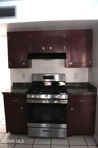 a stove top oven sitting inside of a kitchen