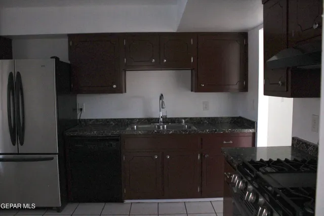 a kitchen with a sink and a stove top oven
