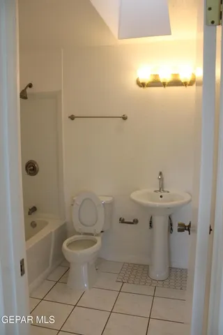 a view of a room that has a window and a white walls