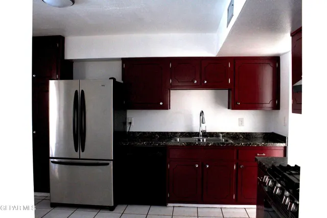 a kitchen with a refrigerator and a sink