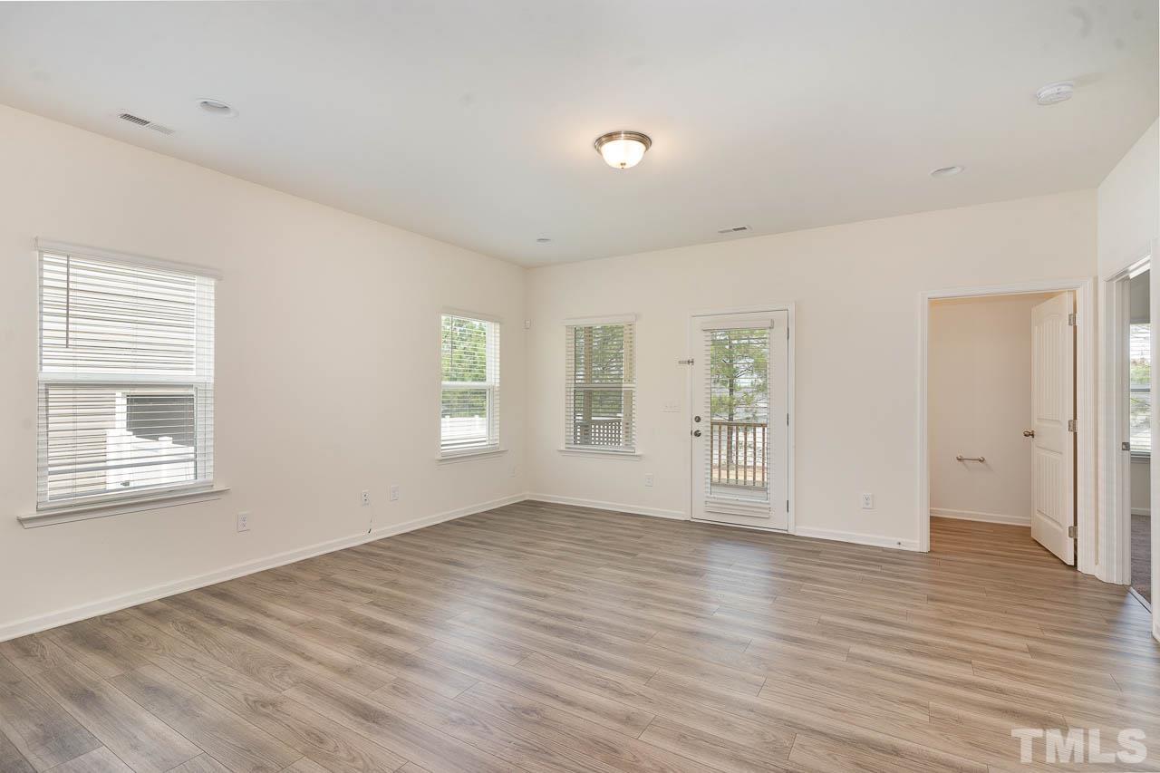 6809 Shane Drive Raleigh, NC 27610 - Photo 11 of 21 an empty room with wooden floor and windows