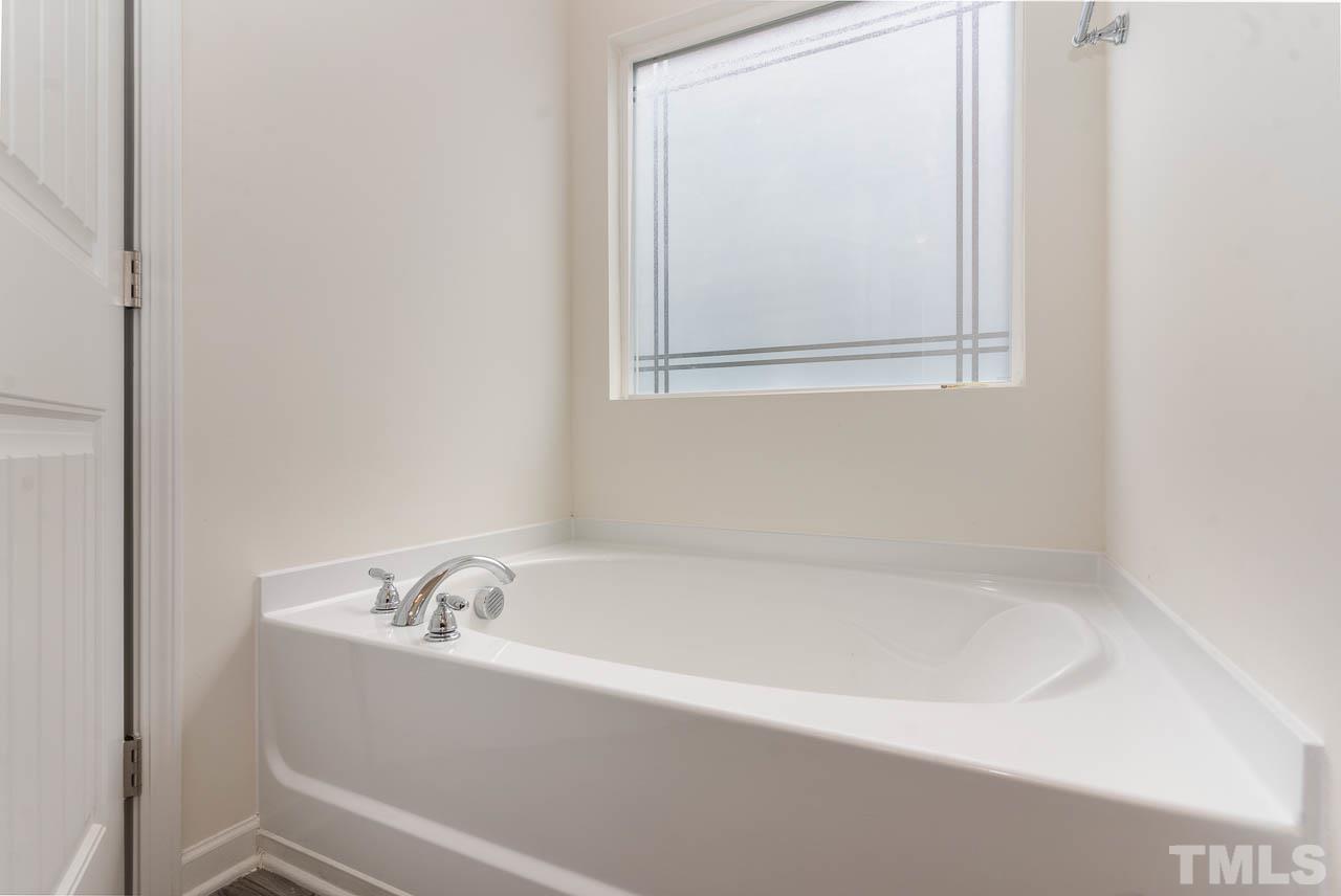 6809 Shane Drive Raleigh, NC 27610 - Photo 17 of 21 a white bath tub sitting next to a white sink