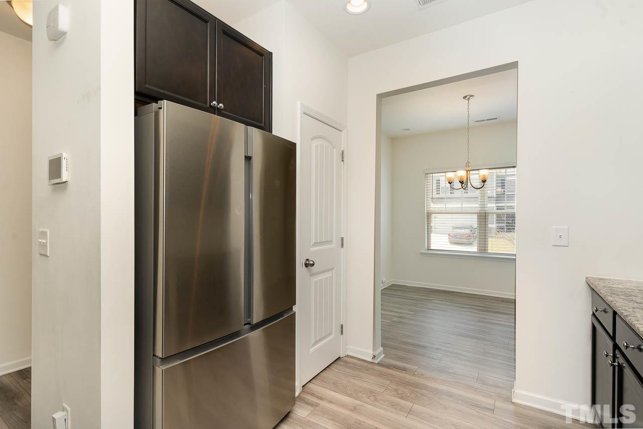 6809 Shane Drive Raleigh, NC 27610 - Photo 8 of 21 a metallic refrigerator freezer sitting inside of a kitchen