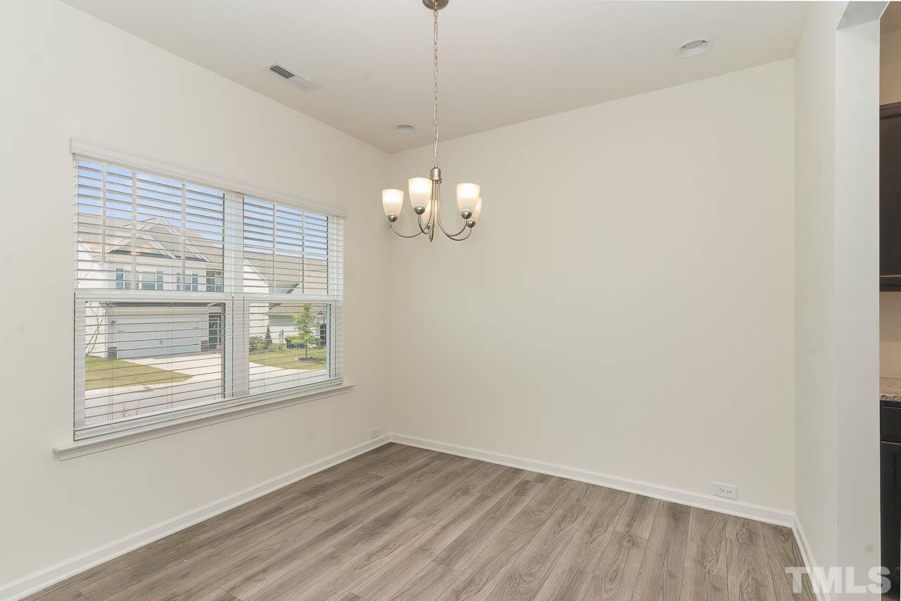 6809 Shane Drive Raleigh, NC 27610 - Photo 9 of 21 a view of an empty room with wooden floor and a window