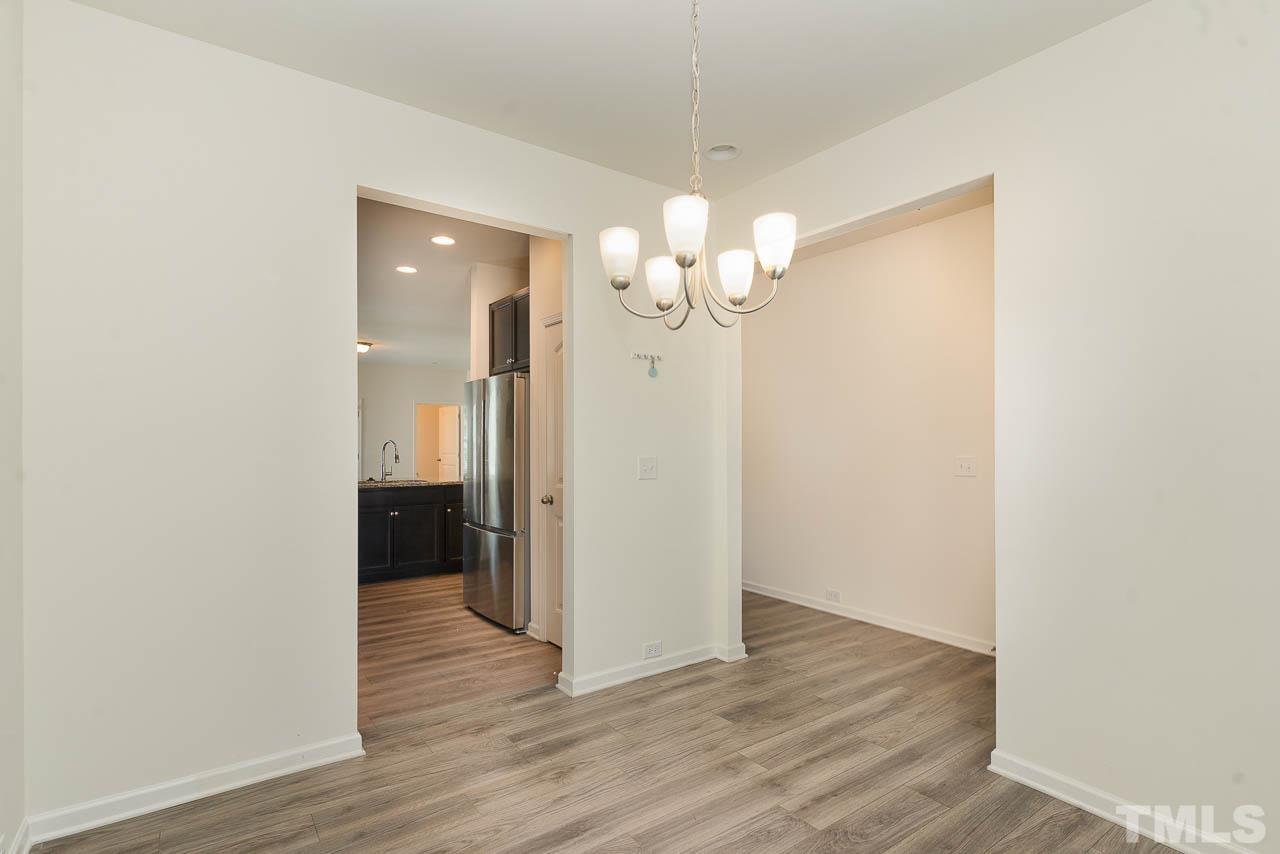 6809 Shane Drive Raleigh, NC 27610 - Photo 10 of 21 an empty room with wooden floor
