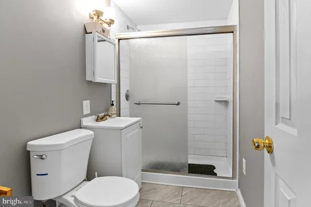 a bathroom with a toilet a sink and shower