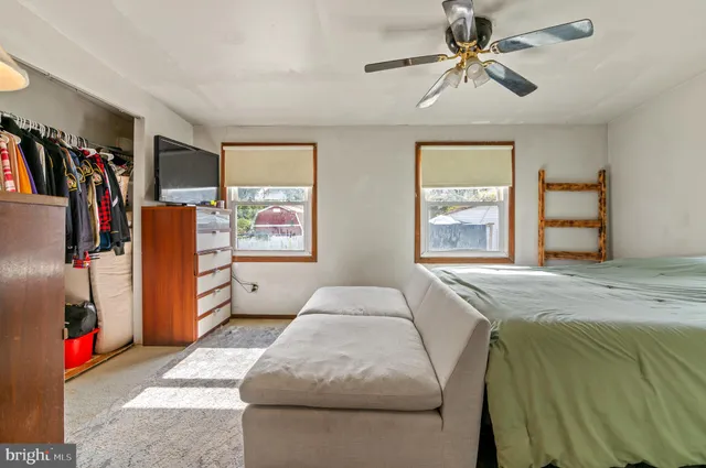 a bedroom with a bed dresser and a window