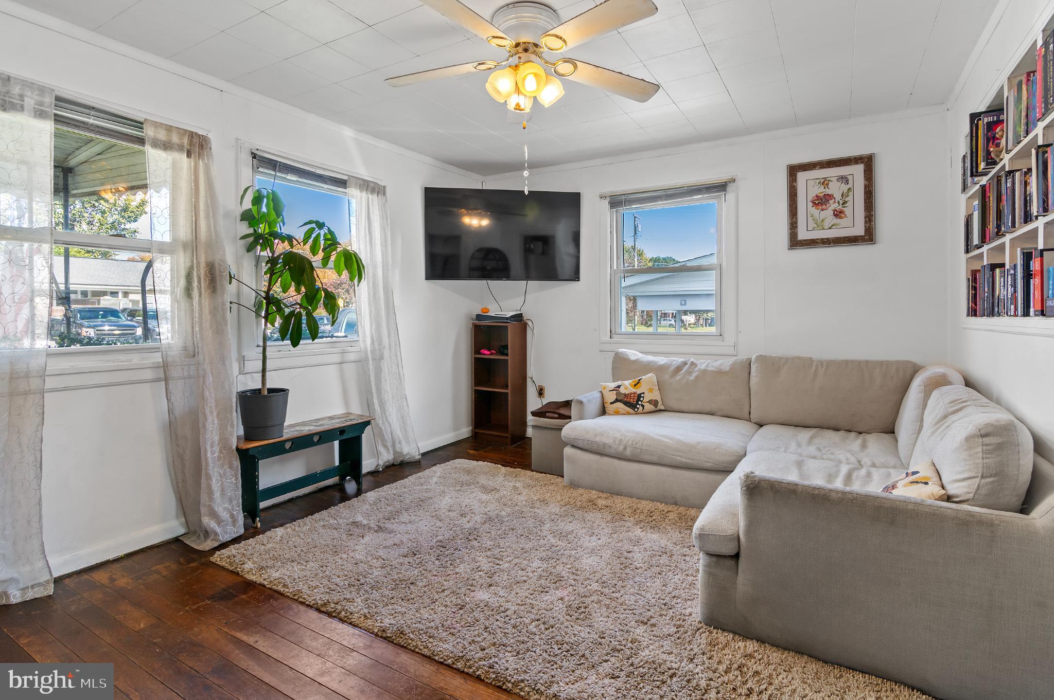 3 Compression Court Middle River, MD 21220 - Photo 5 of 27 a living room with furniture a flat screen tv and a fireplace