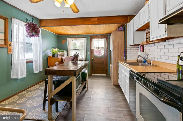 a kitchen with granite countertop lots of counter top space and stainless steel appliances