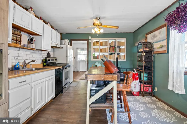 a open kitchen with stainless steel appliances granite countertop a stove and cabinets