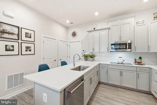a kitchen that has a sink and a stove in it
