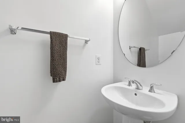 a bathroom with a sink and mirror