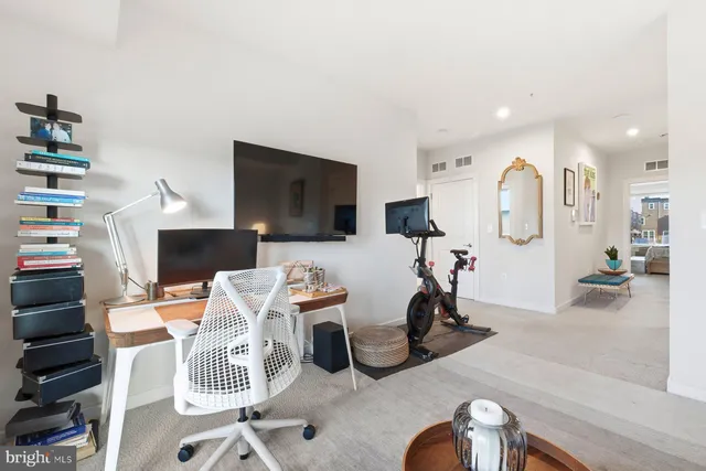 a view of a livingroom with furniture and a flat screen tv