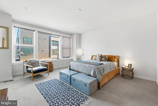 a spacious bedroom with a bed and a couch