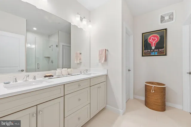 a bathroom with a sink a vanity a mirror and a shower