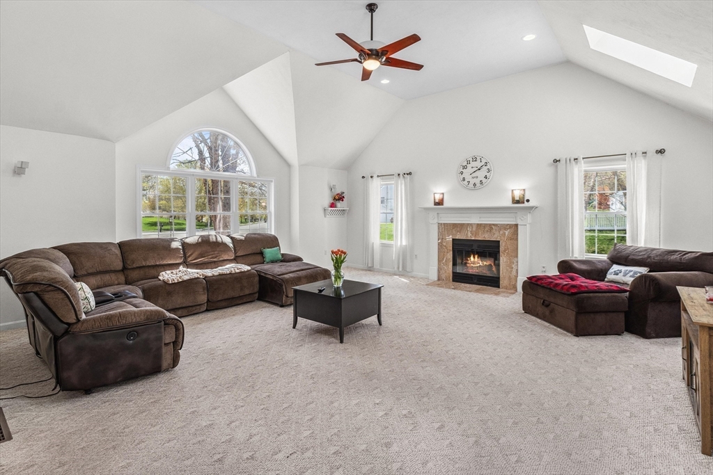 10 Falls Brook Road Hudson, MA 01749 - Photo 17 of 42 a living room with furniture fireplace and a large window