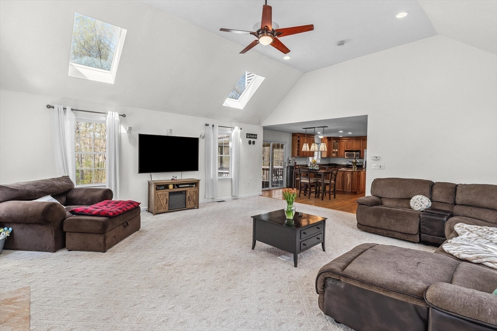 10 Falls Brook Road Hudson, MA 01749 - Photo 18 of 42 a living room with furniture and a flat screen tv