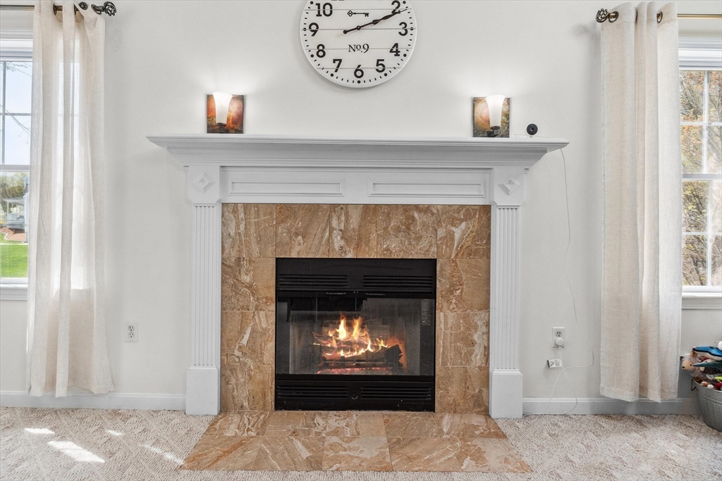 10 Falls Brook Road Hudson, MA 01749 - Photo 19 of 42 a living room with a fireplace and a fireplace