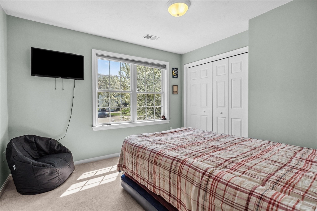 10 Falls Brook Road Hudson, MA 01749 - Photo 24 of 42 a bedroom with a bed and a television