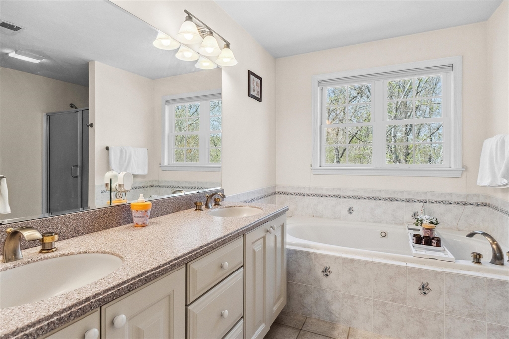 10 Falls Brook Road Hudson, MA 01749 - Photo 29 of 42 a bathroom with a tub sink and mirror