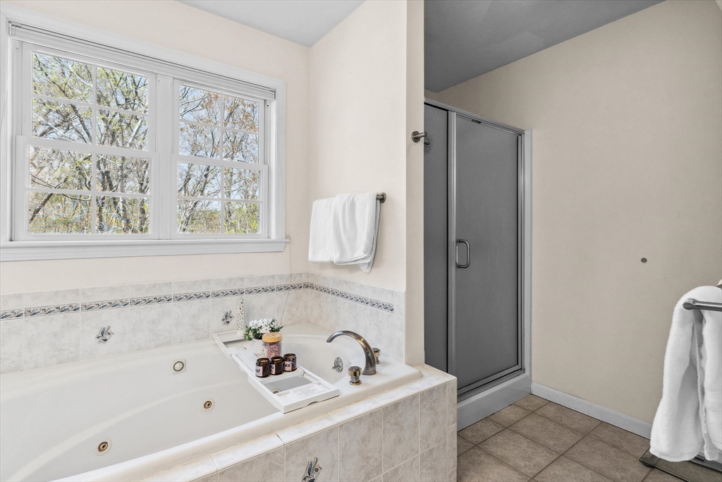 10 Falls Brook Road Hudson, MA 01749 - Photo 31 of 42 a bathroom with a bathtub and a window