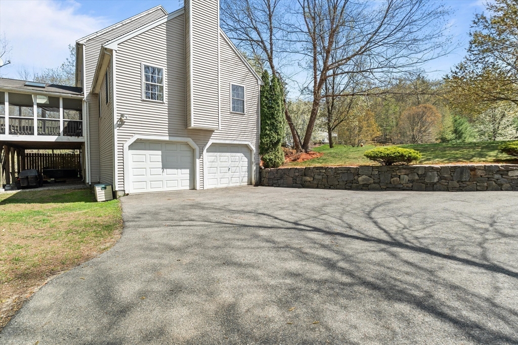 10 Falls Brook Road Hudson, MA 01749 - Photo 37 of 42 a front view of a house with a yard and garage
