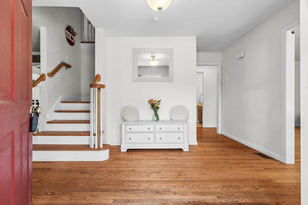 10 Falls Brook Road Hudson, MA 01749 - Photo 4 of 42 a view of a hallway to room with wooden floor and cabinet