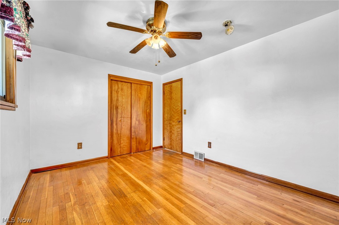 38450 Center Ridge Road North Ridgeville, OH 44039 - Photo 16 of 50 Unfurnished bedroom with a closet, ceiling fan, and light hardwood / wood-style flooring
