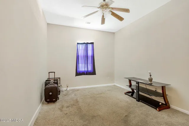 a room with gym equipment and a chandelier