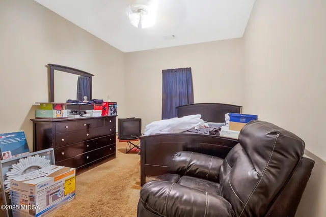 a bedroom with a bed and a couch