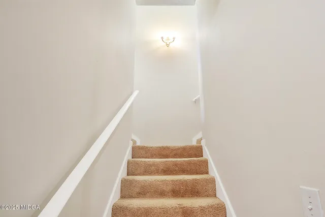a view of staircase with white walls