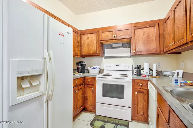 a kitchen with a stove top oven sink and cabinets