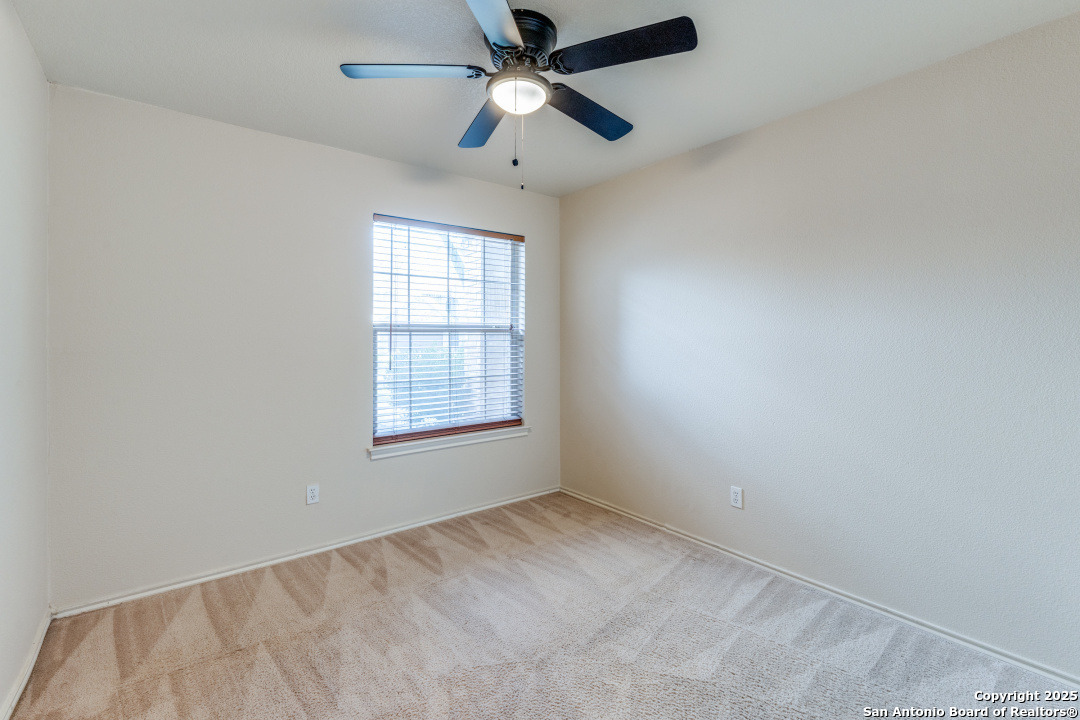 8346 Copperglen Converse, TX 78109 - Photo 11 of 15 an empty room with a window and a fan