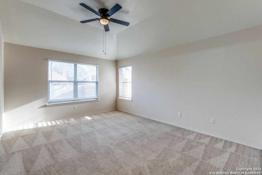 8346 Copperglen Converse, TX 78109 - Photo 12 of 15 an empty room with windows and ceiling fan