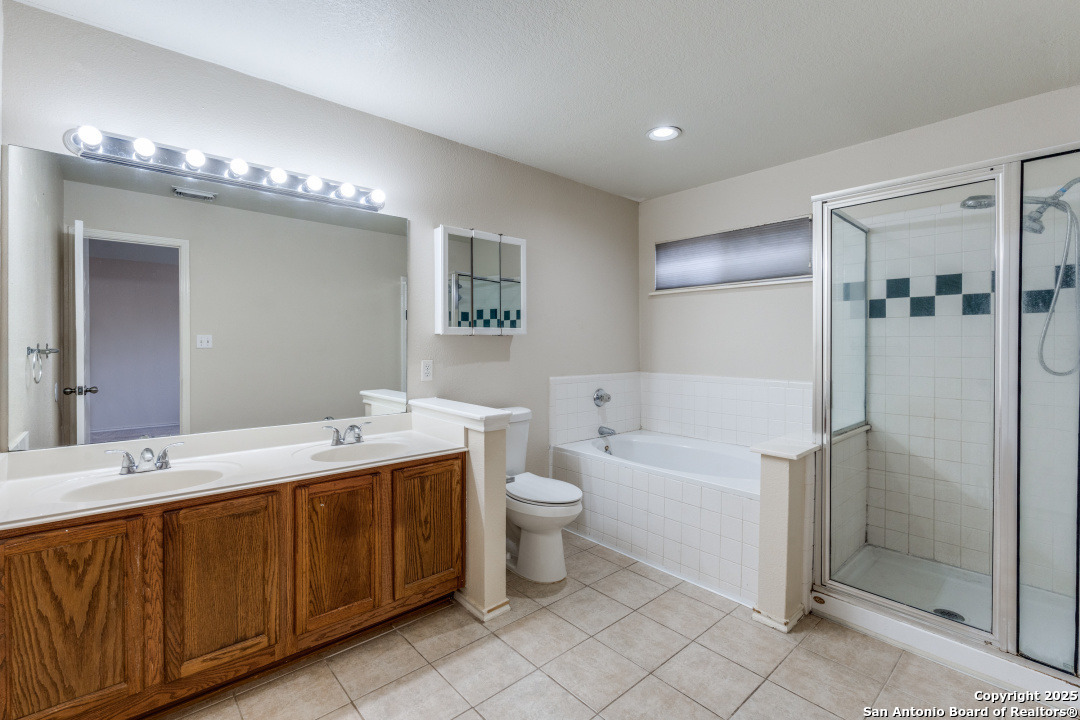 8346 Copperglen Converse, TX 78109 - Photo 13 of 15 a bathroom with a double vanity sink mirror and toilet