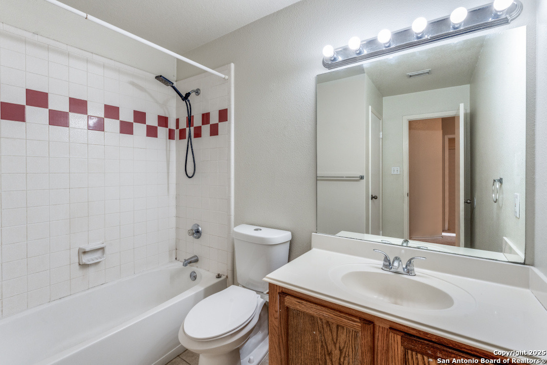 8346 Copperglen Converse, TX 78109 - Photo 14 of 15 a bathroom with a sink a toilet and shower