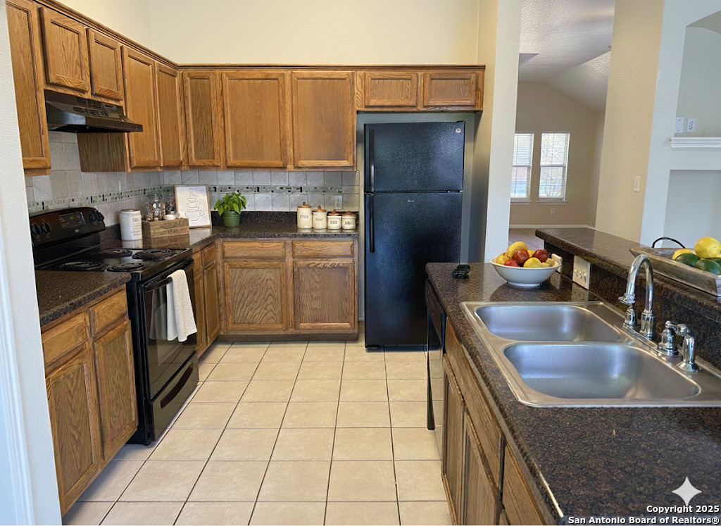 8346 Copperglen Converse, TX 78109 - Photo 4 of 15 a kitchen with a sink a stove top oven and refrigerator
