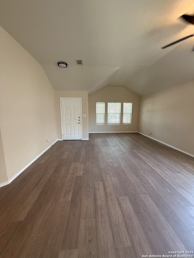 8346 Copperglen Converse, TX 78109 - Photo 8 of 15 wooden floor in an empty room with a window