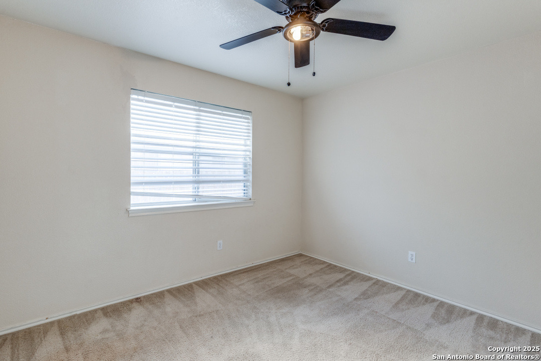 8346 Copperglen Converse, TX 78109 - Photo 10 of 15 an empty room with a window and a fan