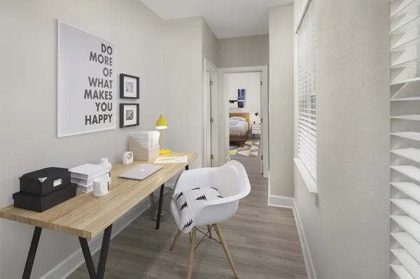 a view of a workspace room with furniture and wooden floor