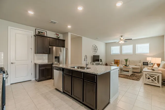 a view of a roof deck with a couches and iron fence