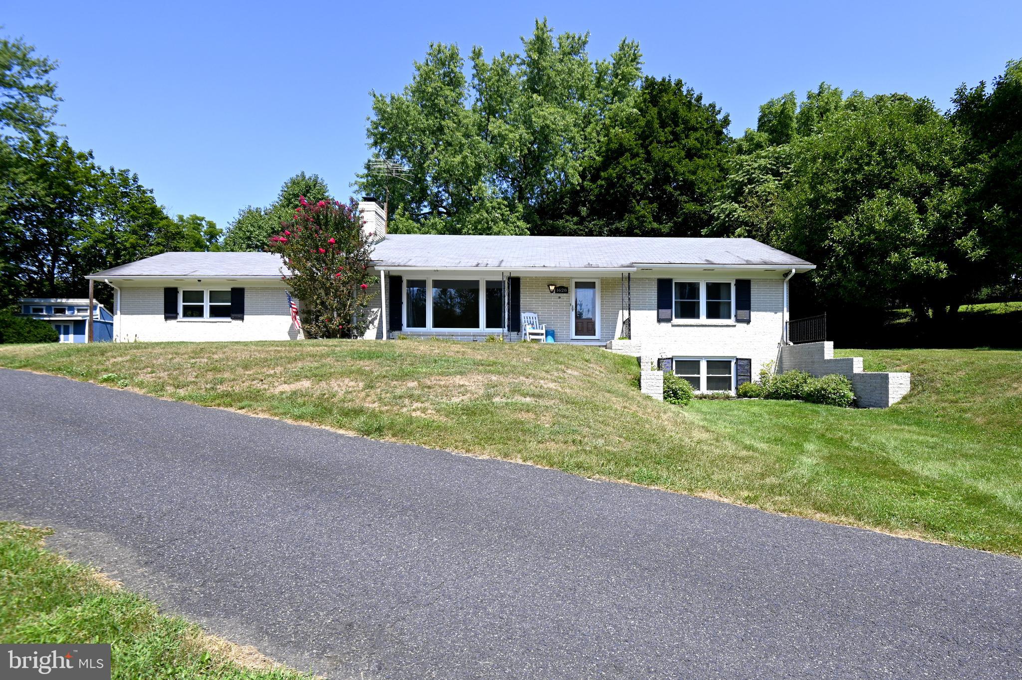 1628 Mayberry Road Westminster, MD 21158 - Photo 1 of 37 White brick rancher, black shutters, and driveway