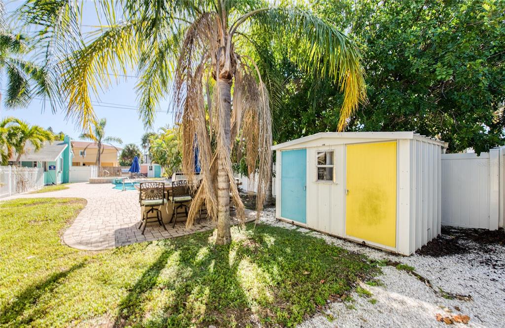 13136 4th Street East Madeira Beach, FL 33708 - Photo 20 of 75 a view of a swimming pool with chairs in patio
