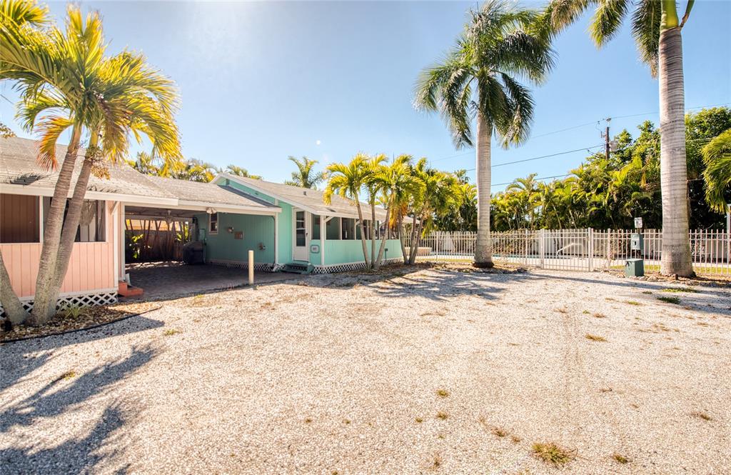 13136 4th Street East Madeira Beach, FL 33708 - Photo 26 of 75 a view of a house with a yard and palm trees