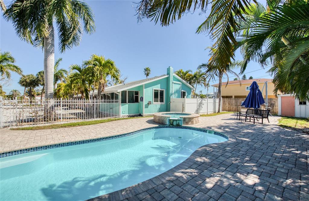 13136 4th Street East Madeira Beach, FL 33708 - Photo 30 of 75 a view of a house with swimming pool and a sitting area