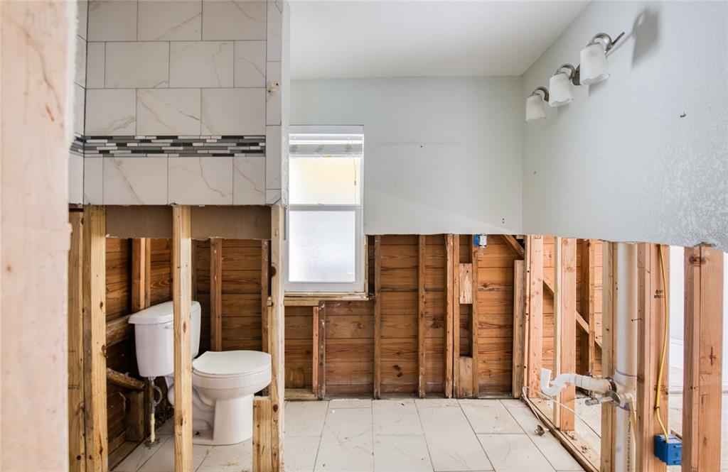 13136 4th Street East Madeira Beach, FL 33708 - Photo 35 of 75 a bathroom with a toilet and a shower