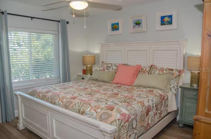 13136 4th Street East Madeira Beach, FL 33708 - Photo 41 of 75 a large bed sitting in a bedroom next to a window