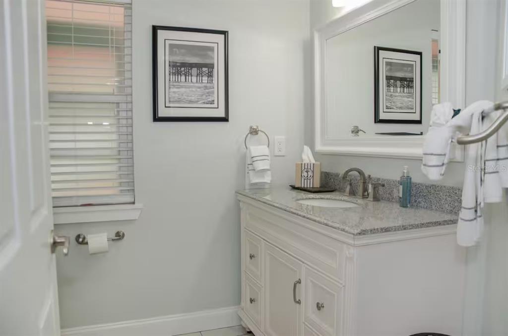 13136 4th Street East Madeira Beach, FL 33708 - Photo 43 of 75 a bathroom with a sink and a mirror